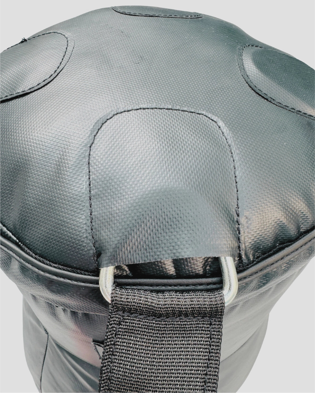 Gray protective knee pad with a strap on a light gray background