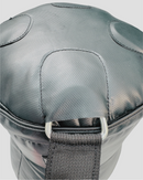 Gray protective knee pad with a strap on a light gray background