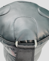Gray protective knee pad with a strap on a light gray background
