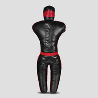 A black leather martial arts dummy with red trim and a red head band, shown from the back on a light gray background.