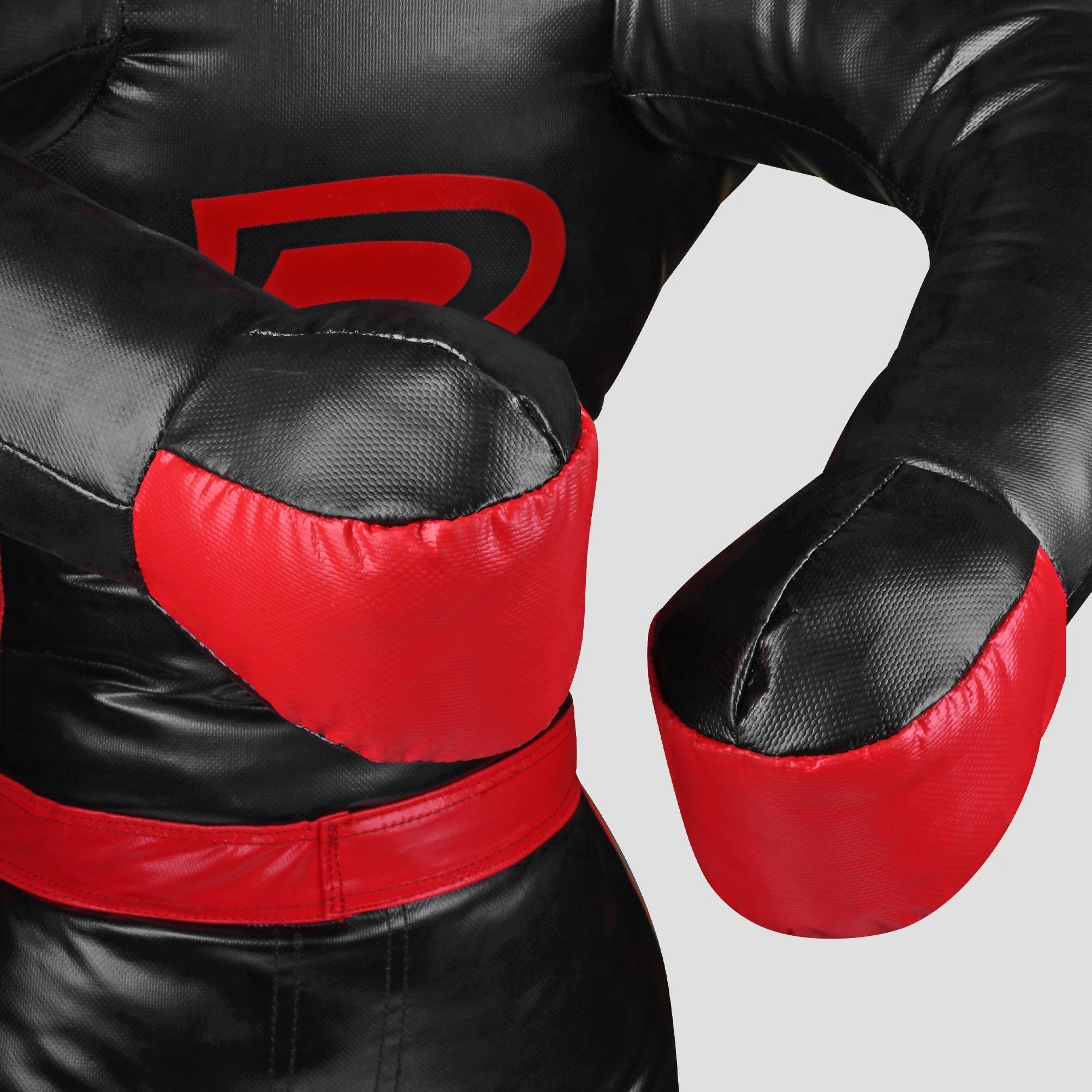 Close-up of a black and red boxing glove training pad or boxing glove cover with a large red logo on the chest, shown against a light gray background.