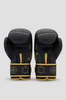 Palm-side view of black and gold DAAN boxing gloves showing inner padding and reinforced wrist straps.