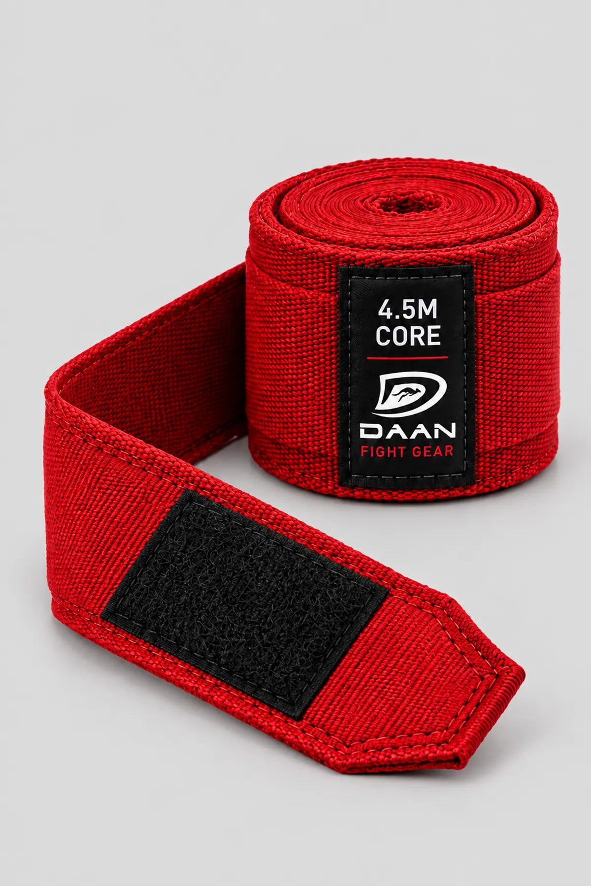 Red DAAN Core 4.5m hand wrap partly unrolled, showing the black hook-and-loop closure