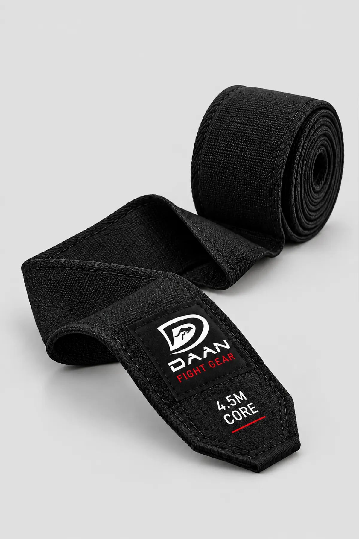 Black DAAN Core 4.5m boxing hand wrap unrolled, showing the stretch weave and labelled tail