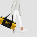 Person holding a yellow and black duffel bag with a logo on a light gray background