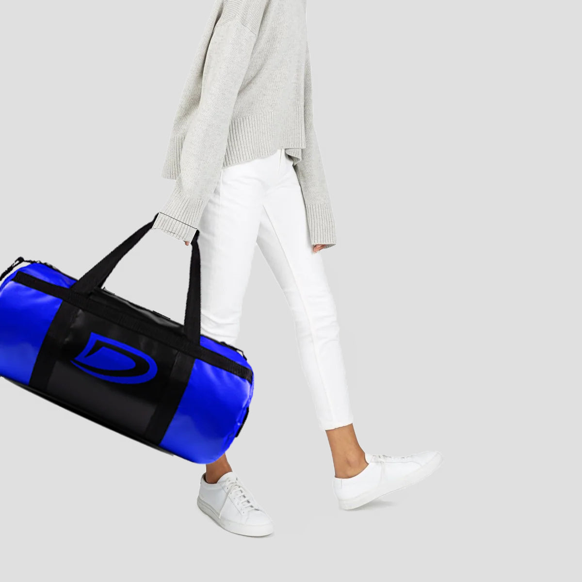 Person holding a blue duffel bag with a logo on a light gray background