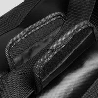 Close-up of a black bag with textured surface and strap