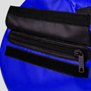 Close-up of a blue bag with a black zipper and strap.