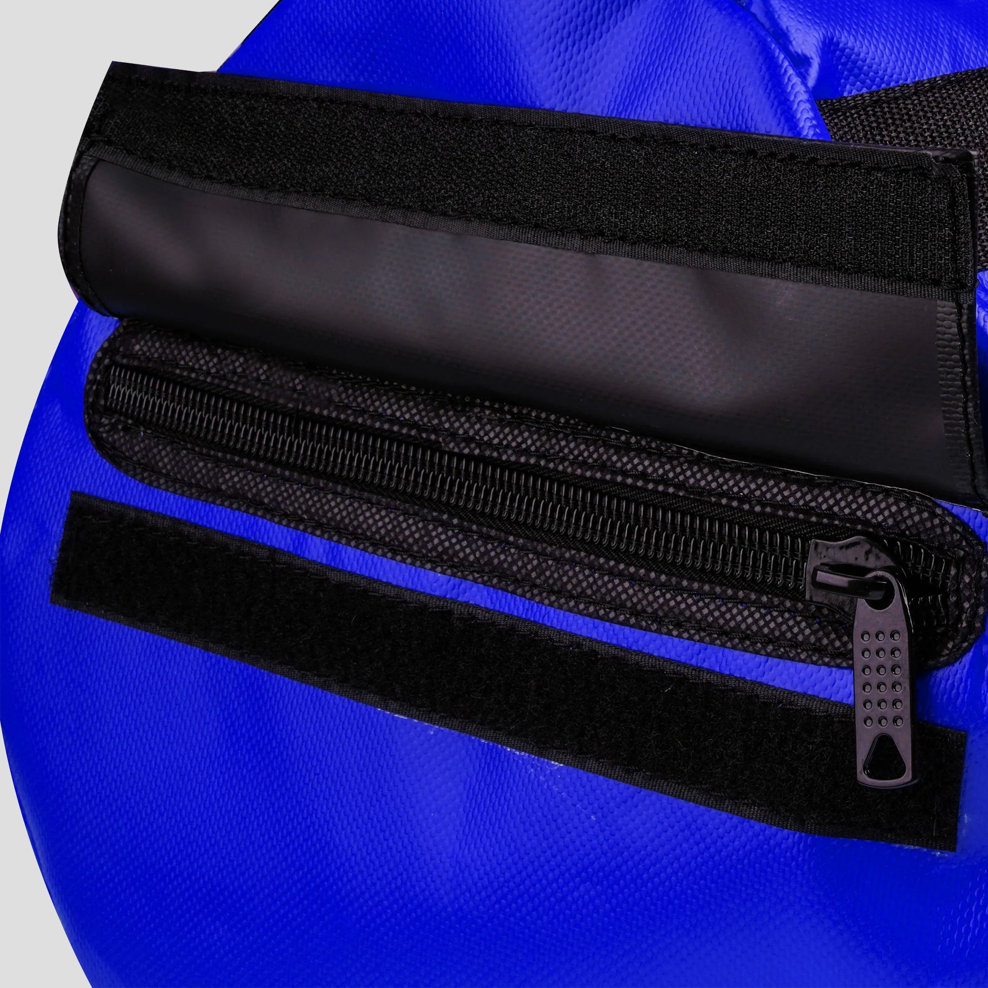 Close-up of a blue bag with a black zipper and strap.