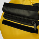 Close-up of a yellow bag with black zippers on a white background