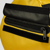 Close-up of a yellow bag with black zippers on a white background