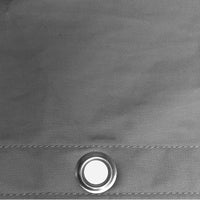 Close-up of a gray fabric surface with a metal grommet.